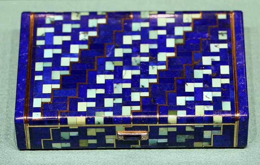 A Cartier cigarette case in lapis and turquoise: A cigarette case of gold, lapis lazuli, turquoise, sapphires and diamonds made by Cartier in Paris in 1930.