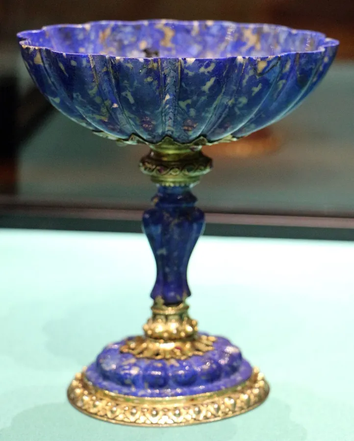 A fluted lapis cup set with cabochons: A fluted lapis lazuli cup with silver mounts set with cabochon stones.