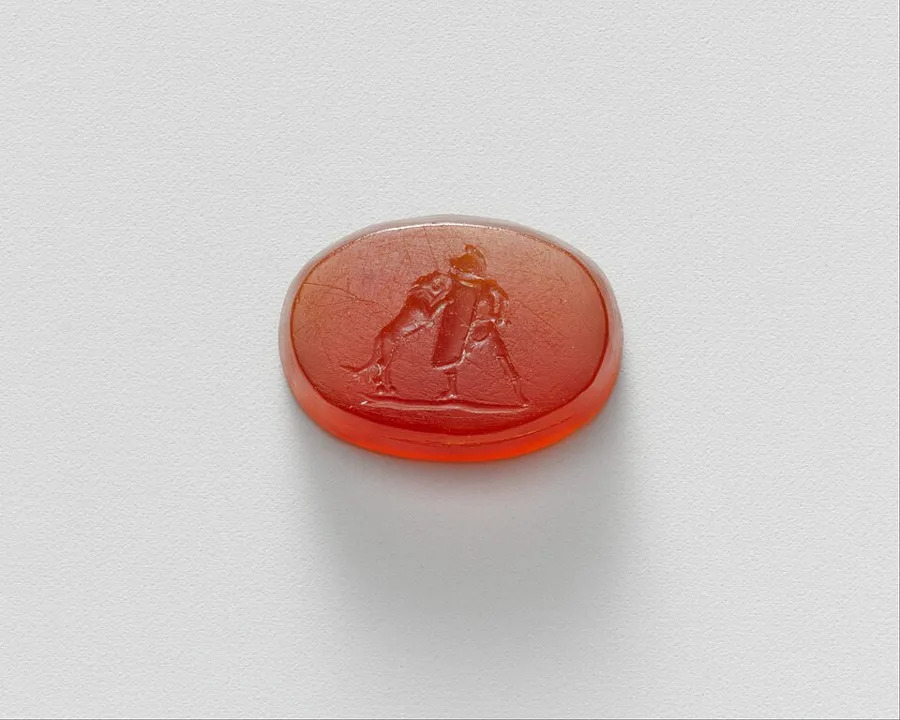 A gladiator fights a lion: A carnelian intaglio 1.5 cm high showing a gladiator battling a lion. Roman, Early Imperial, First half of the 1st century AD.