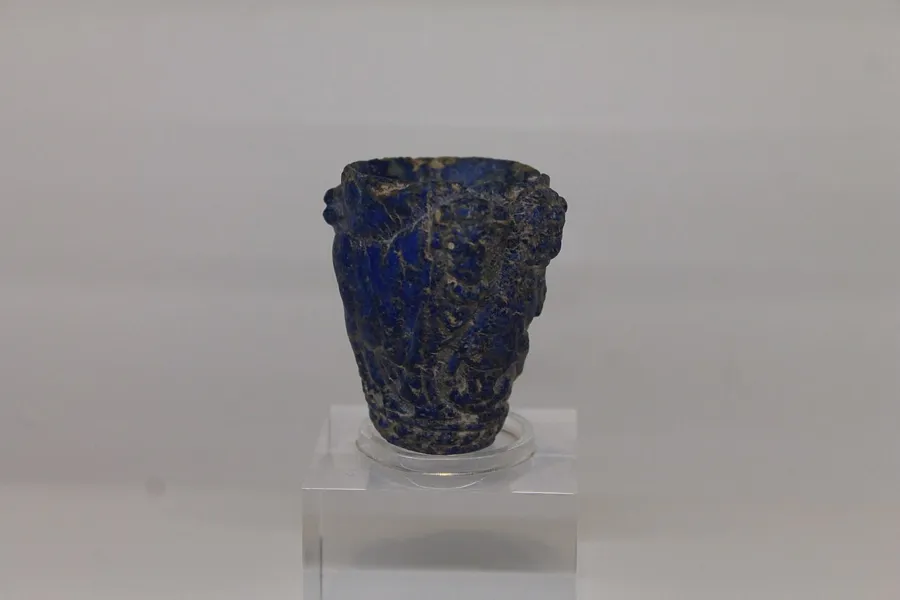 A lapis beaker of bulls and a lion: A small beaker carved from lapis lazuli with domesticated bulls and a lion in relief, from about 3000 BC.