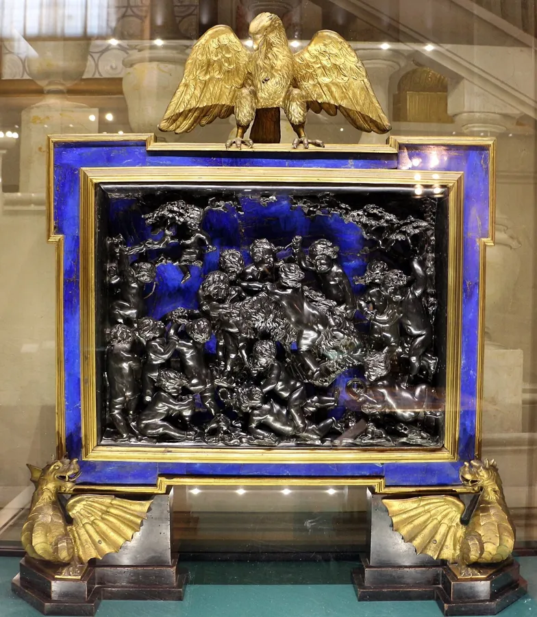 A painting on touchstone and lapis: A bacchanal of putti by Giovanni Campi, set on black touchstone over lapis lazuli.