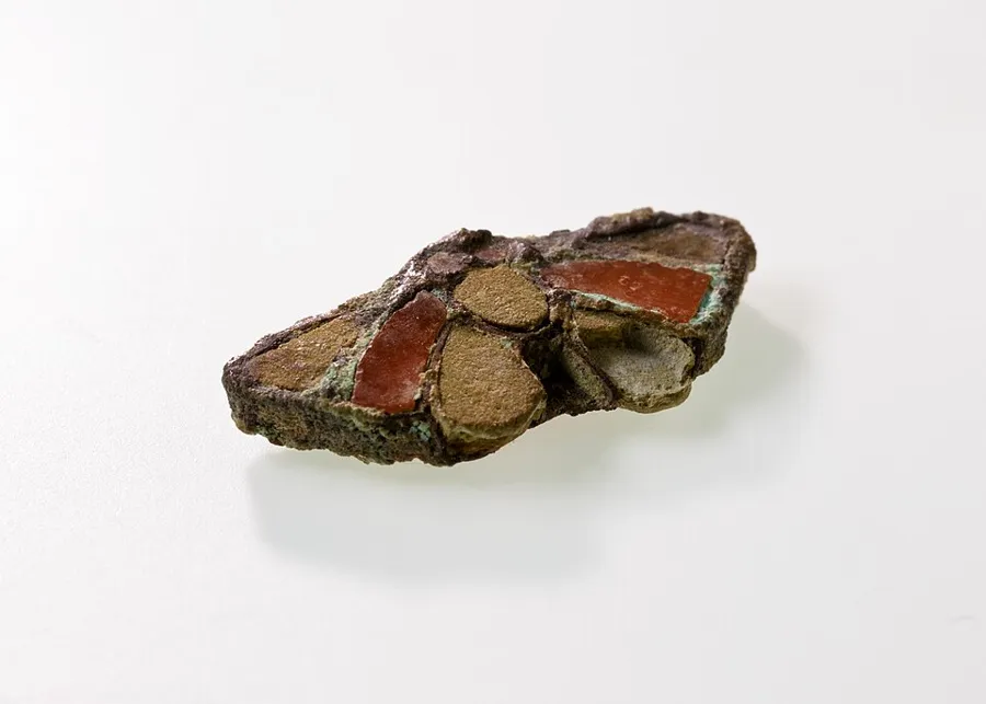 A silver and carnelian butterfly: A butterfly amulet of silver, carnelian and faience, about 2 cm wide. Egyptian, Middle Kingdom, About 1900 to 1802 BC.