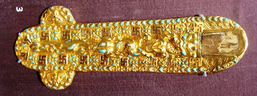 A Tillya Tepe sheath set with turquoise: A sheath for three knives from Tomb IV at Tillya Tepe, of gold and bronze set with turquoise.
