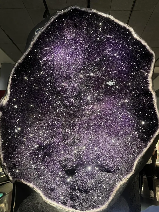 Twin amethyst geodes, 9 and 12 feet tall: A 9 ft, 11,000 lb amethyst geode, shown back to back with a second geode 12 ft tall, both from the Bolsa mine in Uruguay.