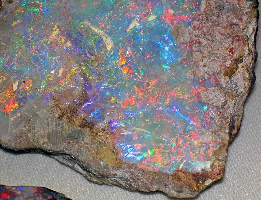 Precious opal in its rock: Opal with play of colour still in its host rock, from the Andamooka opal fields of South Australia.