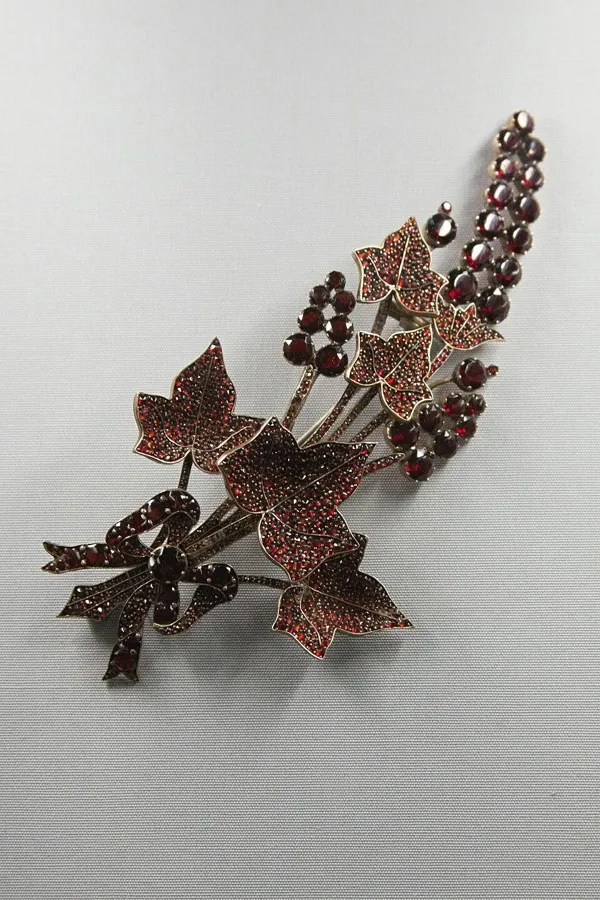 A Bohemian garnet brooch: A brooch of ears of wheat and leaves covered in small Bohemian garnets, 1840 to 1860.