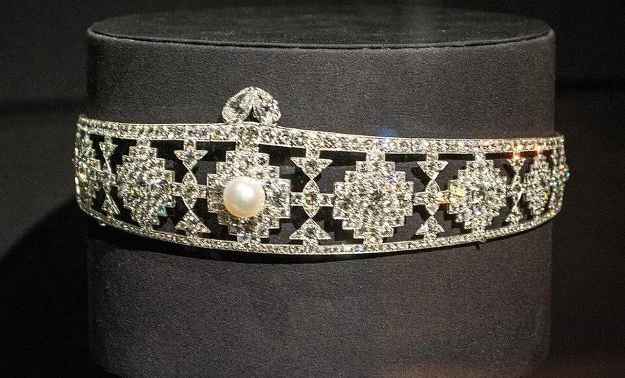 A Cartier diamond bandeau: A diamond headband by Cartier from the Jazz Age, worn low across the forehead.