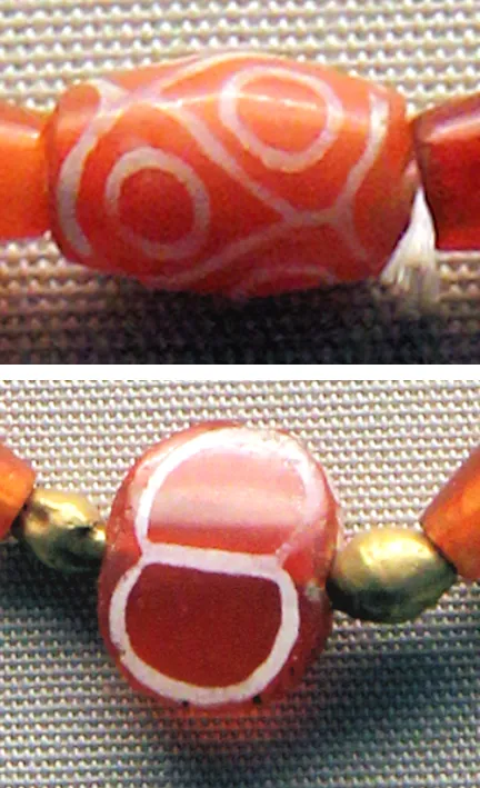 Etched carnelian beads from Ur: Gold and carnelian beads from the Royal Cemetery of Ur, including white-etched carnelian. Sumerian, with Indus beads, About 2600 to 2300 BC.