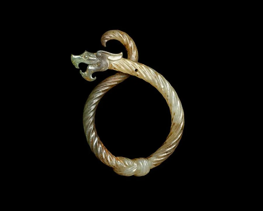 A knotted dragon pendant: A dragon tied in a knot, carved in jade, ancient China.