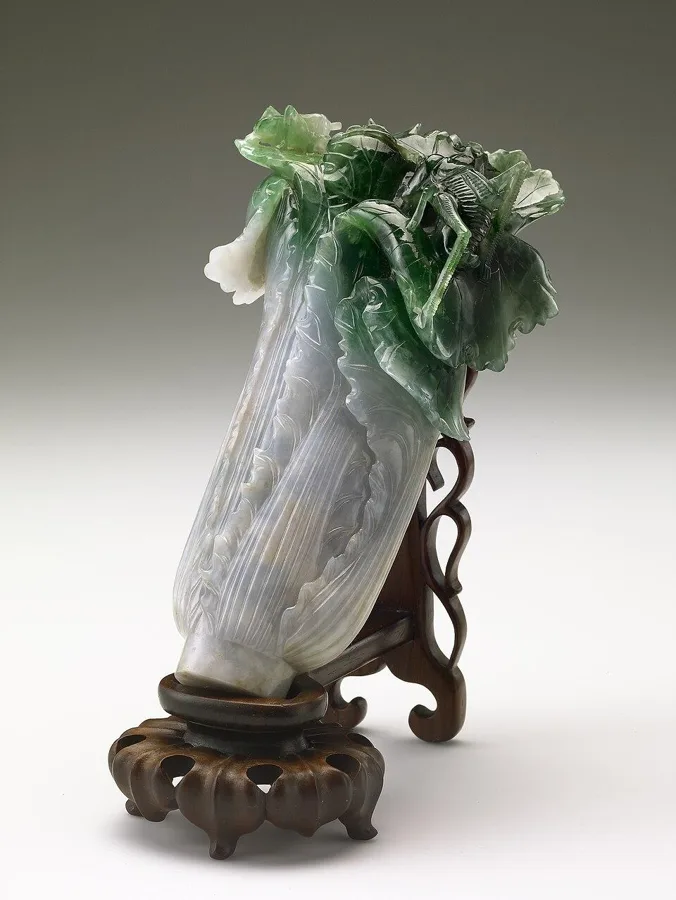 The Jadeite Cabbage: A piece of half-white, half-green jadeite carved as a bok choy with two insects hiding in the leaves, Qing dynasty.