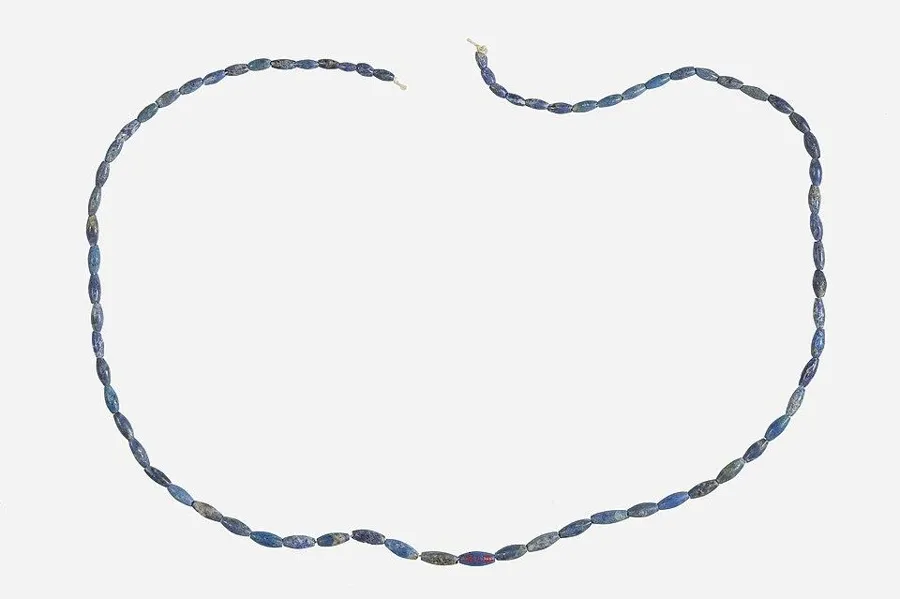 A necklace of lapis barrel beads: A long strand of small barrel-shaped lapis beads, ancient Egypt.