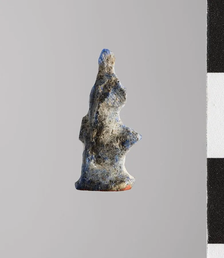 An Isis amulet in lapis: A small figure of the goddess Isis carved from lapis lazuli, ancient Egypt.