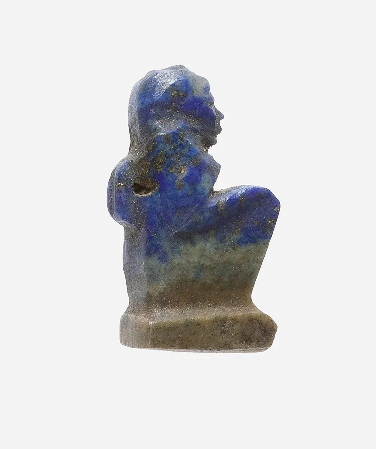 Maat, the goddess of truth, in lapis: A tiny seated figure of Maat, who wears an ostrich feather, ancient Egypt.