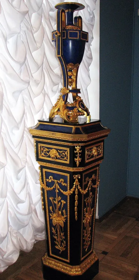 A lapis lazuli vase in the Catherine Palace: A vase of lapis lazuli and gilded bronze on a stand, designed by I. A. Monighetti and made at the Peterhof lapidary factory.
