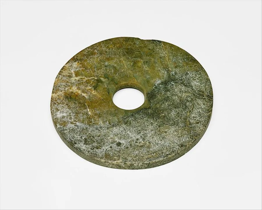 A Liangzhu jade bi disc: A flat nephrite disc with a hole in the centre, Neolithic China.