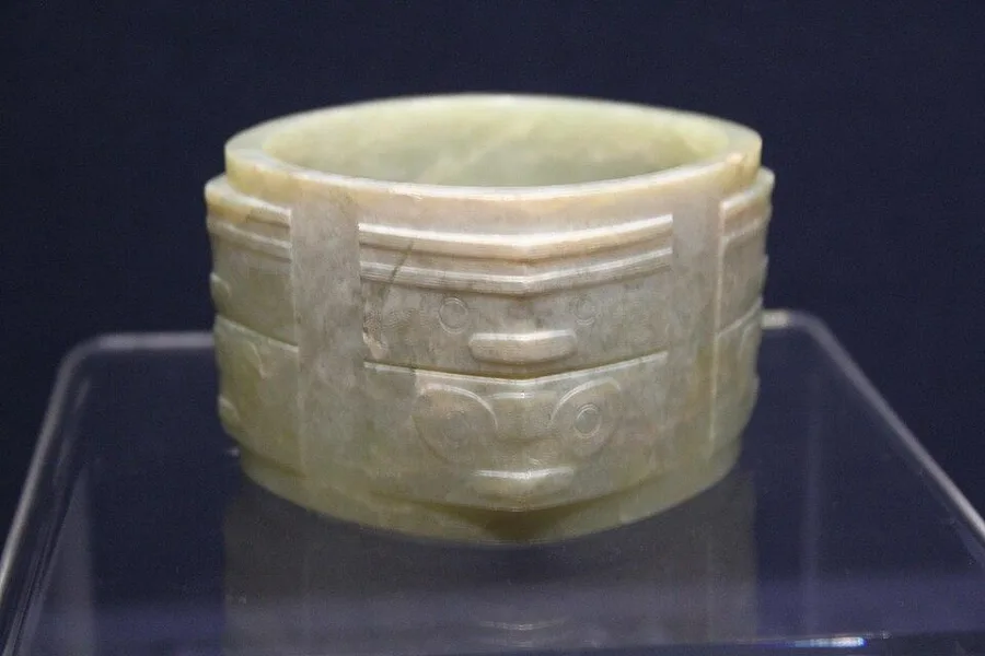 A Liangzhu jade cong: A square tube with a round hole, carved from nephrite about 5,000 years ago.