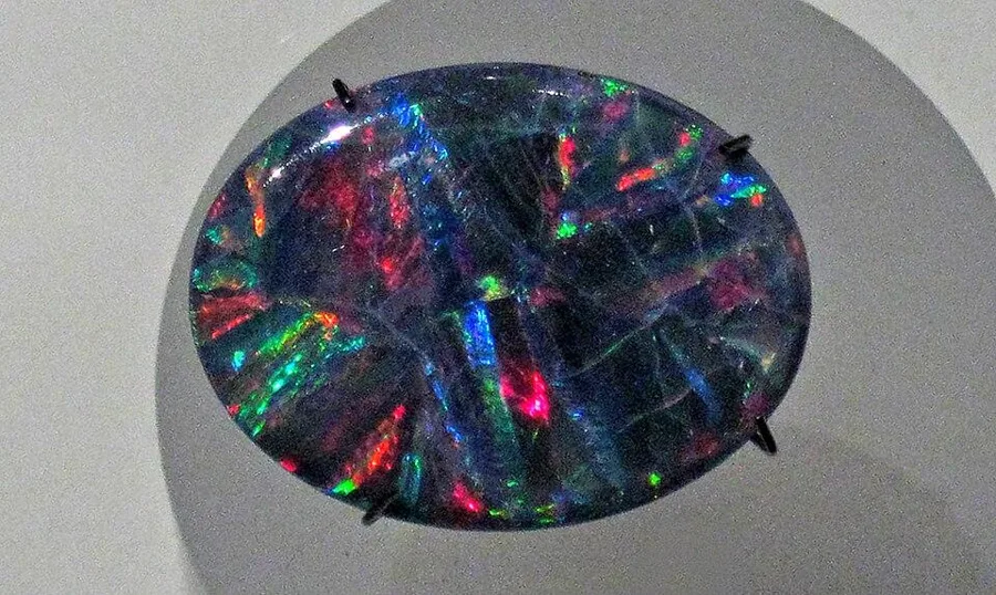A Lightning Ridge black opal: A polished black opal from Lightning Ridge, New South Wales, the only major source of black opal.