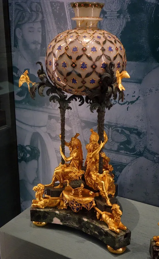 A Mughal hookah base of jade, lapis and rubies: A jade huqqa (hookah) base inlaid with lapis lazuli and rubies set in gold, Mughal India, about 1700, later mounted in Paris in 1798.