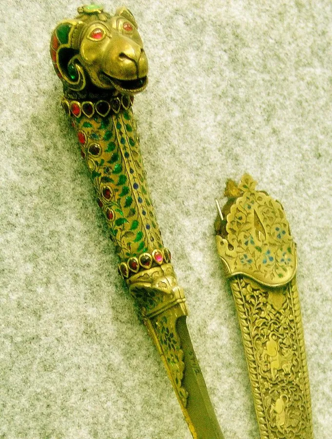 A Mughal dagger with a ram’s head: A jewelled dagger whose hilt ends in a ram’s head, with a matching case, Mughal India.