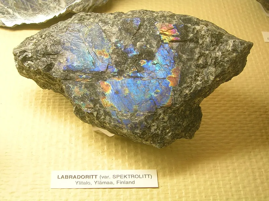 Spectrolite on display in Oslo: A piece of spectrolite, the dark, many-coloured labradorite variety, photographed in an Oslo museum. Spectrolite variety, Natural specimen.