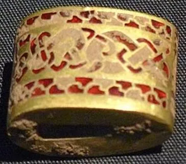 A garnet sword fitting from the Staffordshire Hoard: A gold fitting from a sword, with animals made of thin slices of garnet set in gold cells, 7th century.