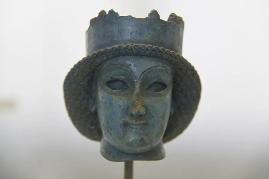 The lapis head of an Achaemenid prince: A small head of a young man wearing a crenellated crown, found at Persepolis and usually described as lapis lazuli. It is one of the best-known pieces in the National Museum of Iran.