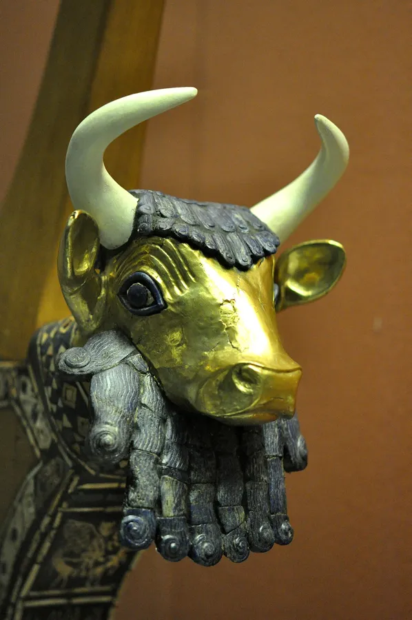The Queen’s Lyre of Ur: A gold-covered bull’s head with eyes of lapis lazuli and shell and hair and beard of lapis lazuli, from a lyre found in the grave of Queen Puabi (PG 800) in the Royal Cemetery at Ur. The head and mosaic are ancient; the wooden body, pegs and strings are modern.