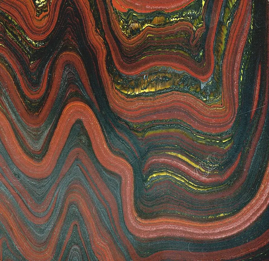 Tiger iron from the Hamersley Range: Folded bands of red jasper, black iron and golden tiger’s eye, about 11 cm top to bottom, from Western Australia.