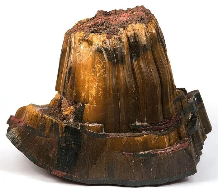 A giant tiger’s eye specimen: A mushroom-shaped mass of tiger’s eye with riebeckite and hematite, about 12 cm across, from Atikokan, Ontario.