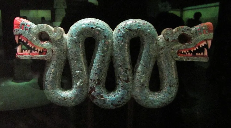 The double-headed serpent: Carved cedar covered in a mosaic of turquoise, with red shell mouths and white shell teeth, Aztec or Mixtec, 15th to 16th century.