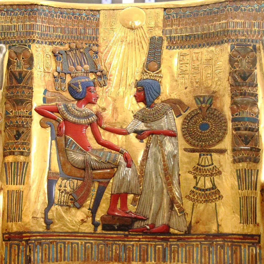Tutankhamun’s golden throne: A wooden throne overlaid with sheet gold and silver and inlaid with coloured glass, faience and semi-precious stones. The back panel shows Queen Ankhesenamun anointing the king under the rays of the Aten.