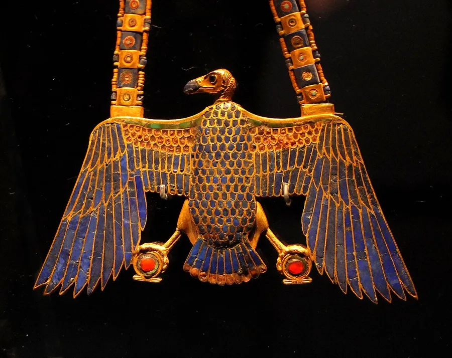 Tutankhamun’s vulture pectoral: A gold vulture pendant set with lapis lazuli, carnelian and blue and red glass, on a chain with a counterpoise. The vulture is Nekhbet, protector goddess of Upper Egypt.