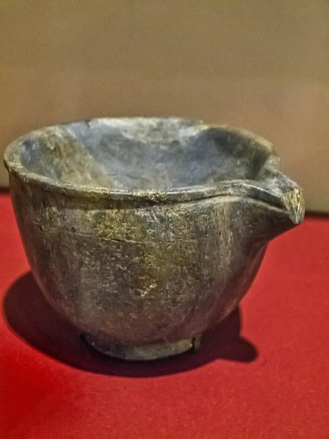 A spouted bowl carved from lapis: A small bowl with a pouring spout, carved from a single block of lapis lazuli, royal cemetery of Ur.