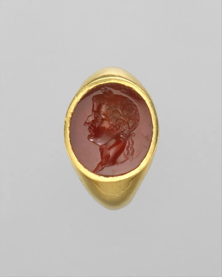 A Roman gold ring with a carnelian intaglio portrait of the emperor Tiberius, carved in reverse to press into wax. Metropolitan Museum of Art.