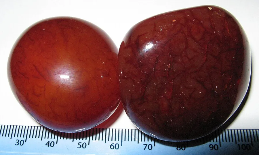 Carnelian and its darker cousin sard, polished: the glow comes from light scattering inside microscopic quartz fibres.