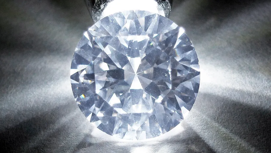 A cut cubic zirconia under strong light, showing the coloured flashes that give it away.