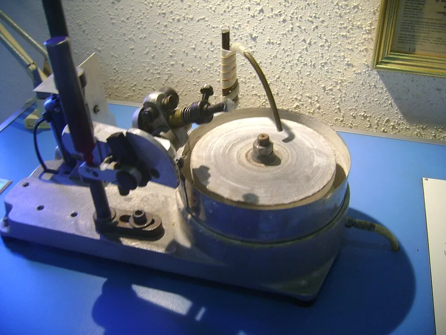 A faceting machine: the stone is held on a dop at an exact angle above a spinning lap.