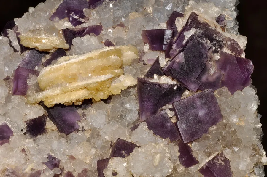 Purple fluorite cubes with pale barite blades, from Morocco.