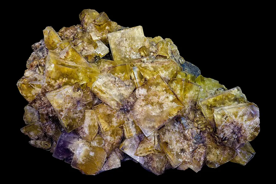 Fluorite cubes from Peyrebrun, France: yellow with purple corners, grown in a mineral vein.