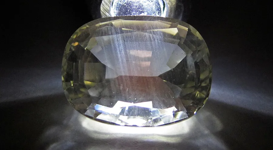A faceted 5.8 carat Oregon sunstone from the Spectrum Mine, Oregon, about 1.3 cm across.