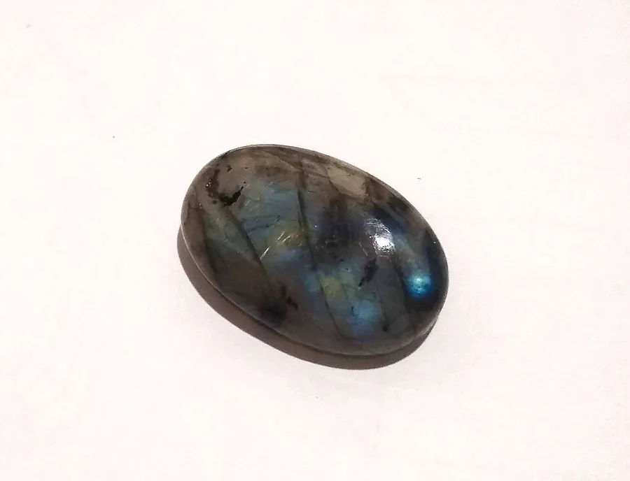 A Brazilian labradorite cabochon. The colour sits in patches rather than an even rainbow.