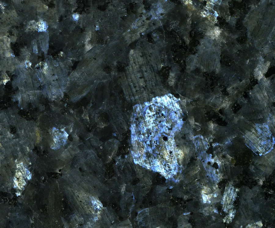 Polished larvikite, sold as Blue Pearl granite. Turn it and the feldspar crystals light up silver-blue.