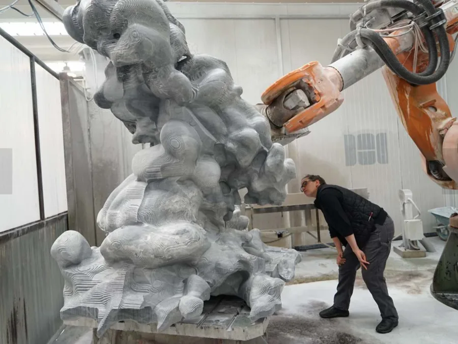 Sculptor Karen LaMonte with Cumulus, a marble she made with weather models, a supercomputer and robots.