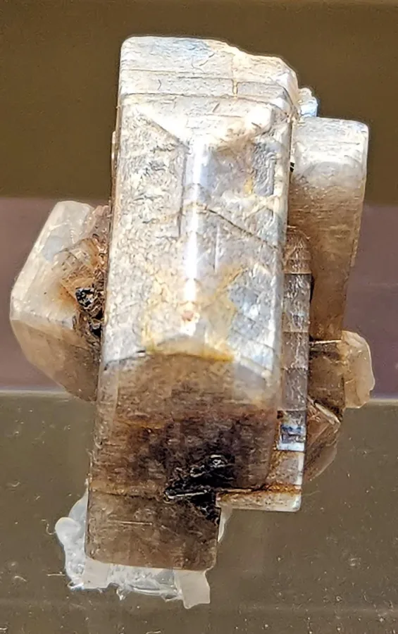 A moonstone crystal from Santo Domingo, Sonora, Mexico, at the Natural History Museum of Los Angeles. Uncut, it looks like any feldspar; the glow appears when it is cut into a dome.