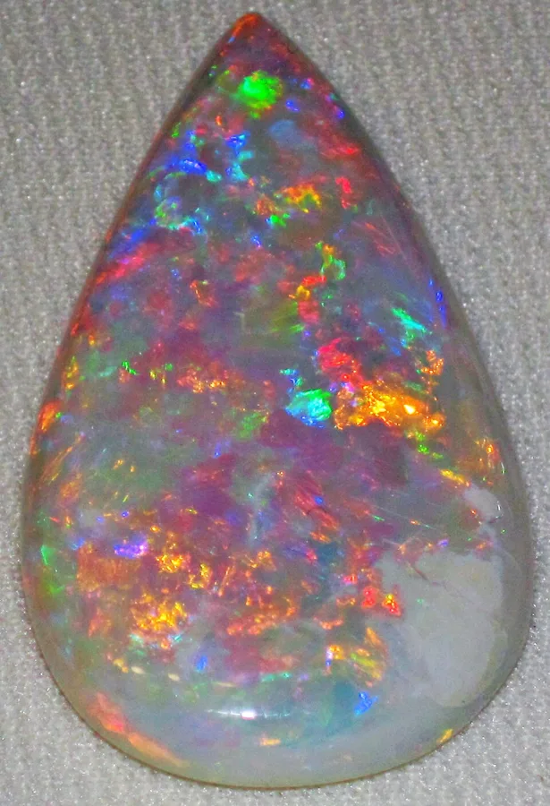 A polished precious opal from Coober Pedy showing play of colour.