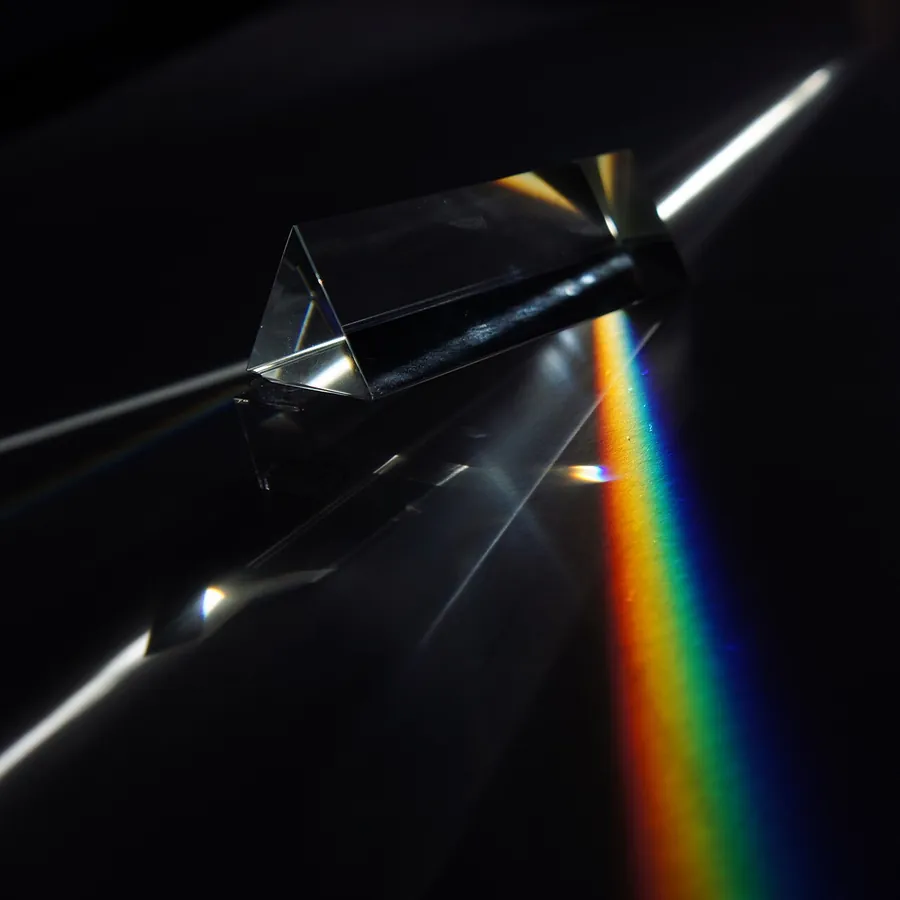 White light split into a rainbow by a glass prism