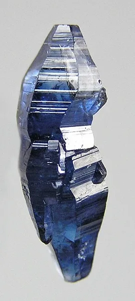 A natural blue sapphire crystal: the six-sided, barrel-shaped form corundum grows in.